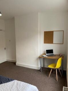 This cozy double bedroom features a comfortable...