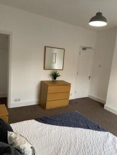 This inviting double bedroom features a comfort...
