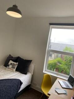 This cozy double bedroom features a comfortable...