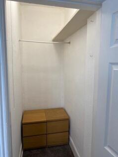 This cozy storage area offers practical solutio...