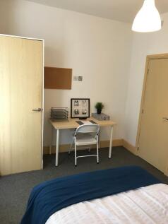 This cozy double bedroom features a comfortable...