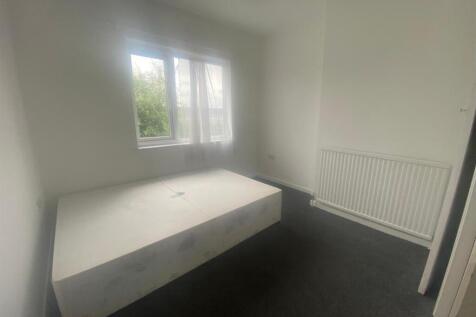 Spacious and bright double bedroom featuring la...