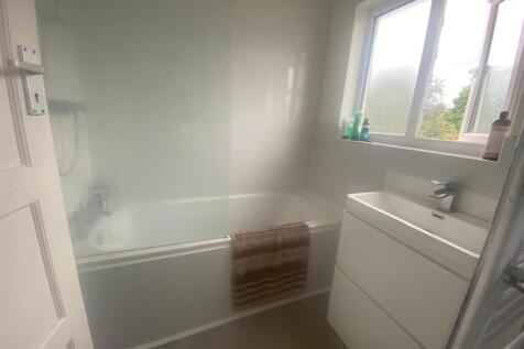 A modern bathroom featuring a sleek design with...
