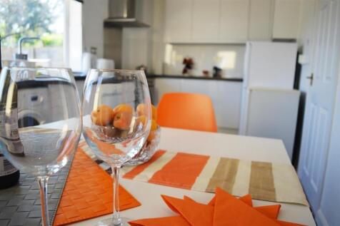 Bright and modern kitchen featuring sleek count...