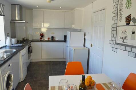 This bright and modern kitchen features sleek c...
