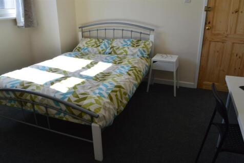Comfortable double bedroom featuring ample natu...
