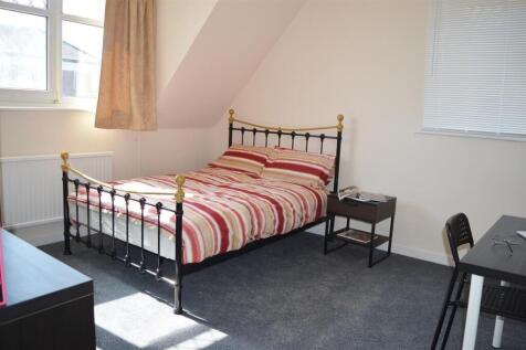 Spacious double bedroom featuring a comfortable...