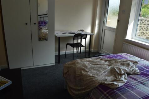 Cozy double bedroom featuring ample natural lig...