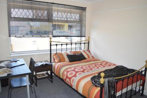 Cozy double bedroom featuring a comfortable bed...