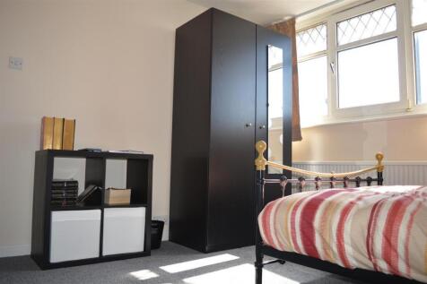 This charming double bedroom features a cozy at...