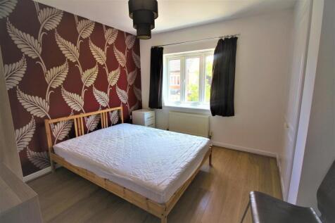 This charming double bedroom features a cozy wo...