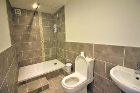 A modern bathroom showcasing sleek tiling and a...