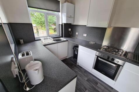 Modern kitchen featuring sleek cabinetry and am...