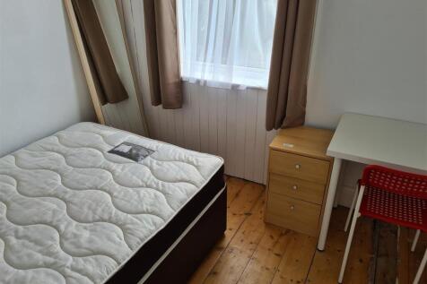 This cozy double bedroom features a comfortable...
