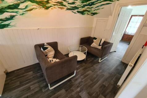 A cozy communal lounge featuring modern seating...