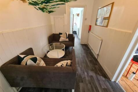A cozy communal lounge featuring comfortable se...