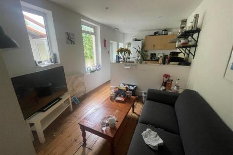 A cozy living room featuring a comfortable sofa...