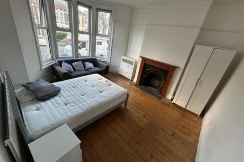 Spacious double bedroom featuring large windows...