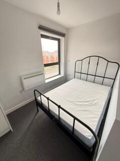 Cozy double bedroom featuring a stylish black m...