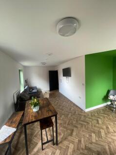 Spacious and inviting living room featuring a c...