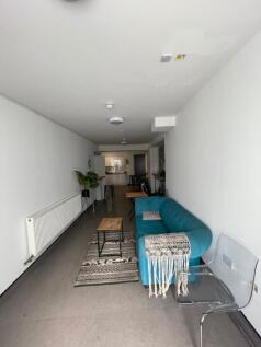 This stylish living room features a cozy turquo...