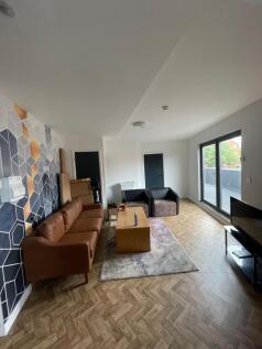 A spacious and inviting living room featuring m...