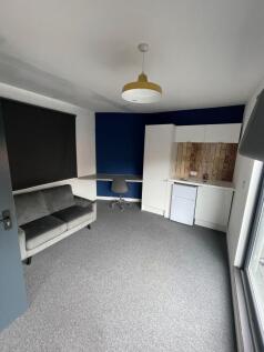 This modern double bedroom features a cozy atmo...