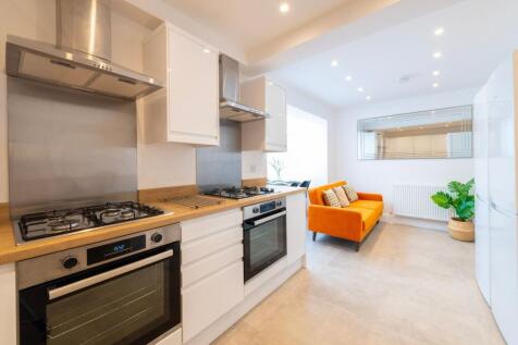 This modern kitchen features sleek cabinetry, s...