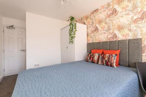 This charming double bedroom features a cozy at...
