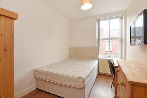 This cozy double bedroom features a comfortable...