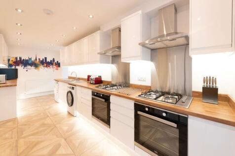 Modern kitchen featuring sleek cabinetry, high-...