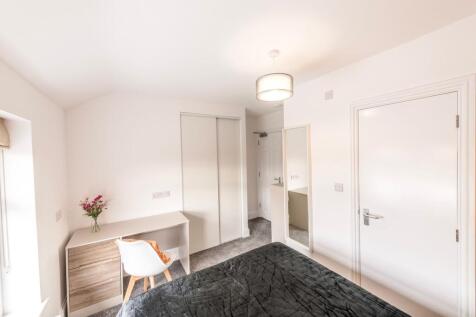 This inviting double bedroom features a comfort...