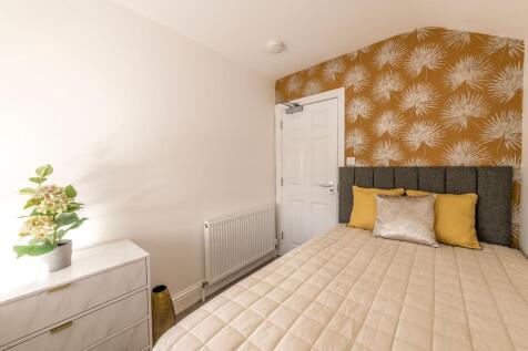 A beautifully styled double bedroom featuring a...