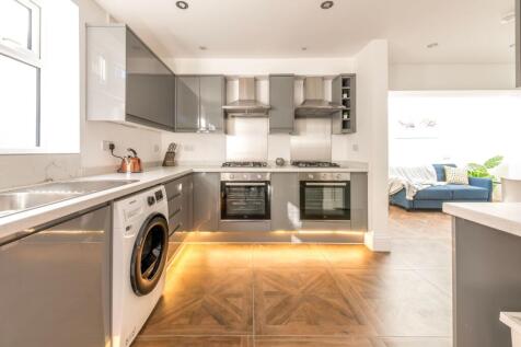 This modern kitchen features sleek cabinetry an...