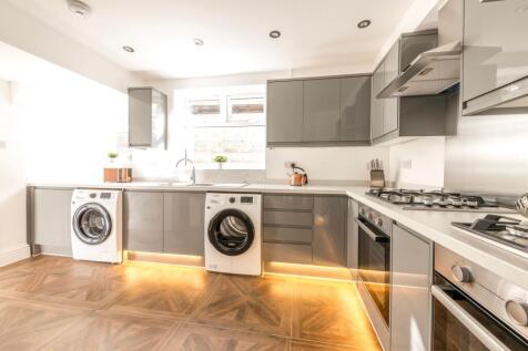 Modern and stylish kitchen featuring sleek cabi...