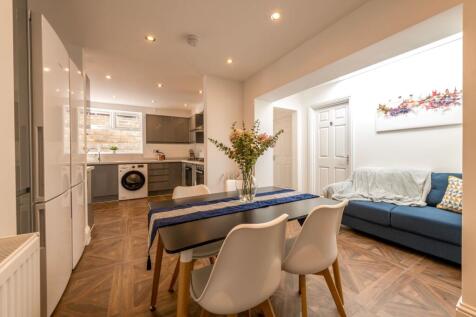 Modern kitchen featuring sleek cabinetry, a spa...