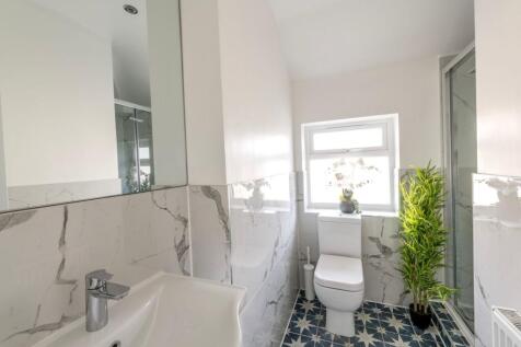 This stylish bathroom features modern fixtures,...