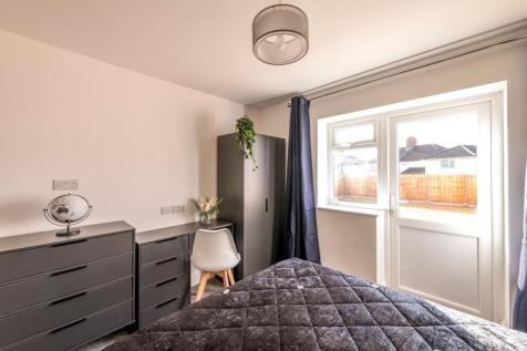 This charming double bedroom features abundant ...