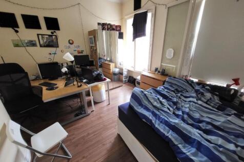A cozy double bedroom featuring ample natural l...
