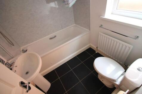 Bright and modern bathroom featuring a stylish ...