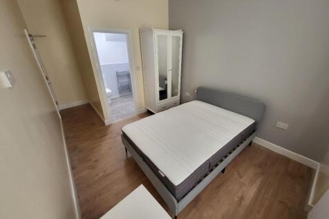 This inviting double bedroom features a cozy la...