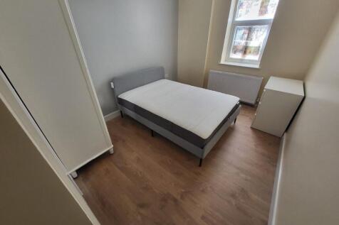 This cozy double bedroom features ample natural...