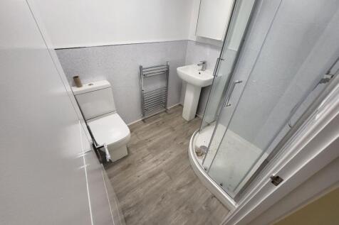 A modern bathroom featuring a sleek shower cubi...