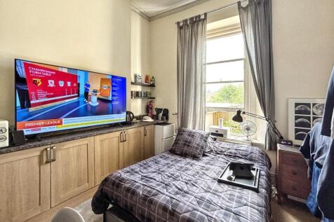 This cozy double bedroom features a comfortable...