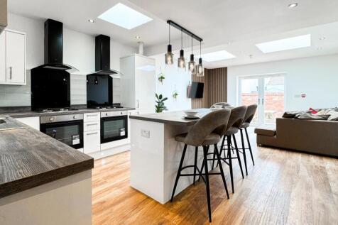 This modern kitchen features sleek cabinetry an...
