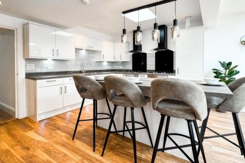 A modern kitchen featuring sleek cabinetry and ...