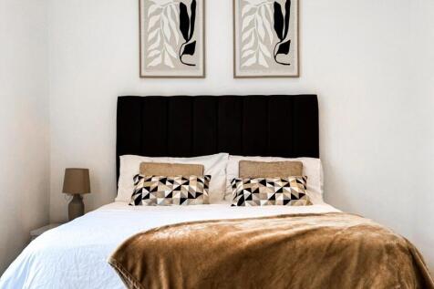 This inviting double bedroom features a cozy am...