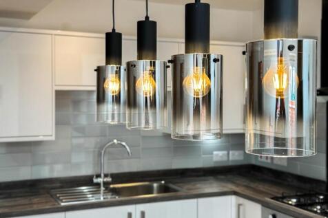Modern kitchen featuring sleek cabinetry, styli...