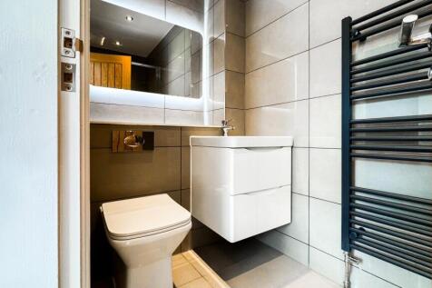 Stylish and modern bathroom featuring sleek fix...