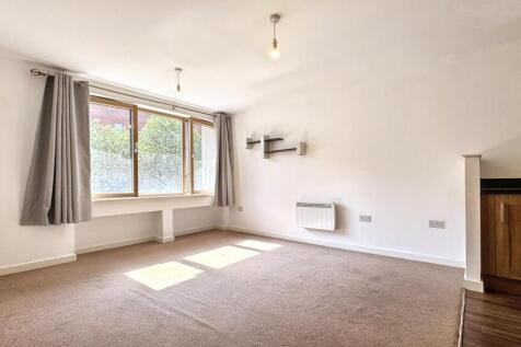 Bright and inviting living room featuring large...